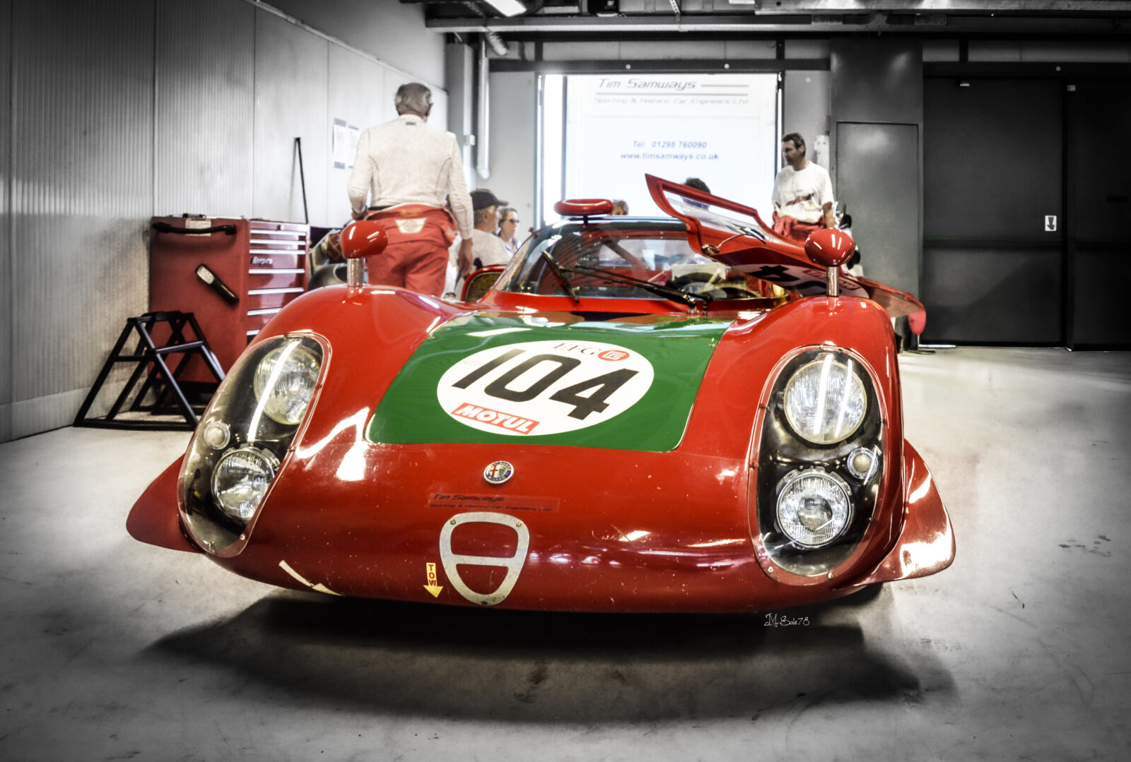 Alfa Romeo 33/2 rossa e verde numero 104 in garage a Monza, vista frontale